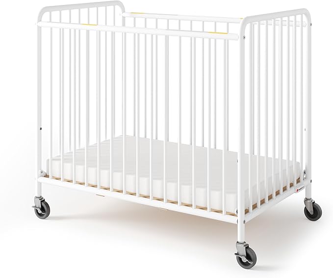 Foundations Chelsea Slatted Metal Compact Daycare Crib, 3" Casters, Compact Mini Size, Easy to Clean Durable Finish, Adjustable to Two Heights Mattress Board (White)